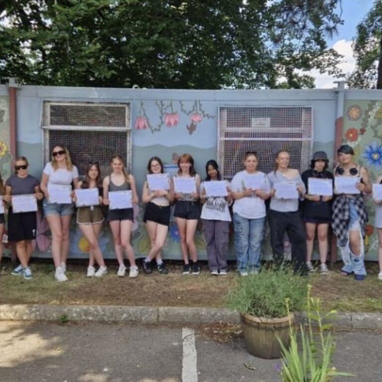 Art students pictured near the mural they painted for Headway Charity during the Queen Mary's College Social Action Week